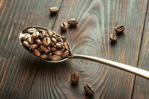 Spoon of coffee beans photo