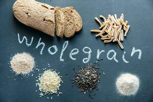 Wholegrain products on the dark wooden background photo