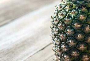 Pineapple on the wooden background photo