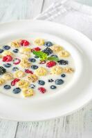 Cereal with milk and berries photo