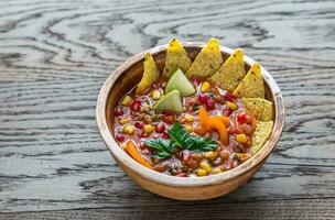 Mexican tortilla soup on the wooden background photo