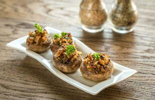 Mushrooms' caps stuffed with mixture of cheese, onion, breadcrum photo