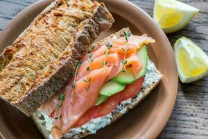 Sandwich with salmon, avocado and tomatoes photo