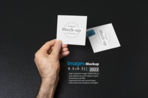 hand holding a blank note paper or image frame on dark background psd