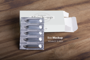 Suppositories loafs on an empty box on wooden table background psd