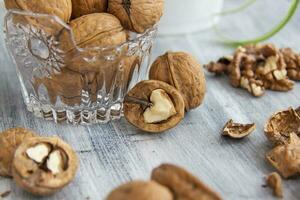 Walnuts on a painted background. Crystal bowl with nuts. Useful products. photo