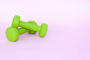 un verde manzana, y un centímetro medición cinta en un rosado antecedentes. Deportes, Deportes nutrición, sano comiendo, dieta. espacio para el texto. foto