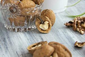 Walnuts on a painted background. Crystal bowl with nuts. Useful products. photo