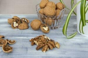 Walnuts on a painted background. Crystal bowl with nuts. Useful products. photo