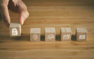 wooden cube block of cyber security icons on wooden table. cyber security, innovation technology, cloud computing, internet network communication concept. photo