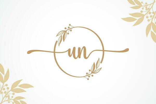 luxury gold signature initial un logo design isolated leaf and flower