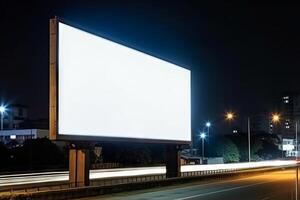 A large blank billboard stands on the side of a road at night.communication, Marketing and Advertising concept. AI Generated. Generative AI. photo