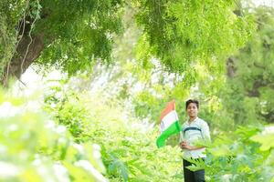 Indian boy holding national flag in farm, happy boy, national flag photo