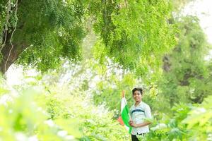 Indian boy holding national flag in farm, happy boy, national flag photo