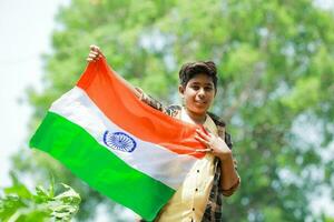 Indian boy holding national flag in farm, happy boy, national flag photo