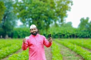 Indian farmer Holding gullak in hand, saving concept, happy poor farmer photo