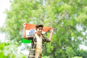 Indian boy holding national flag in farm, happy boy, national flag photo