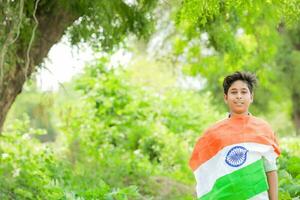 Indian boy holding national flag in farm, happy boy, national flag photo