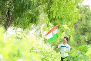 Indian boy holding national flag in farm, happy boy, national flag photo