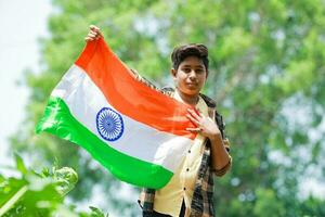 Indian boy holding national flag in farm, happy boy, national flag photo