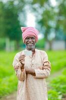 Indian farmer Holding gullak in hand, saving concept, happy poor farmer photo