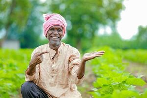 indio contento granjero demostración vacío manos, contento antiguo pobre granjero foto