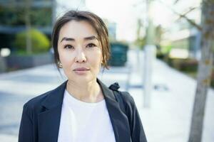 Relaxed Asian confident business woman in suit. Job, work aspirational banner photo