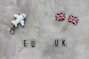 Airplane model, UK flags and text EU UK photo