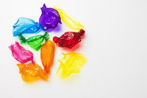 Colorful candy wrappers on white background, copy space photo