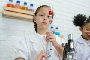 Cute little girl student Lovely scientist enjoy Scientific experiment children at chemistry lesson making Research concept. photo