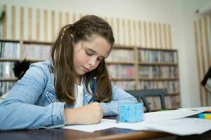 Portrait of lovely girl drawing with colorful pencils at lesson photo