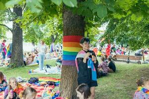 Prague, Czech Republic - August 7, 2021. People with rainbow flags at Pride picnic event at Pride Village, Prague Pride festival photo