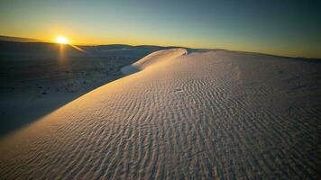 Sunrise over dune at White Sands National Park photo