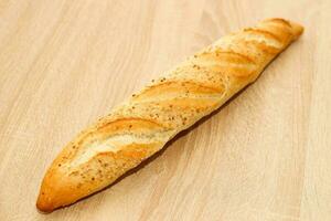 Fresh baguette made of white wheat flour with seeds and cereals photo