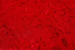 Texture of red velor corduroy fabric with folds photo