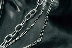 Chain on black texture eco soft leather, fashionable jacket photo