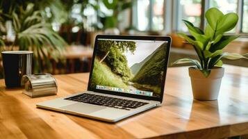 open laptop and in use on a wooden table. photo