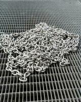 iron chain. A big shiny chain. A shiny iron chain lying on the floor. Boat chain at the boat dock photo