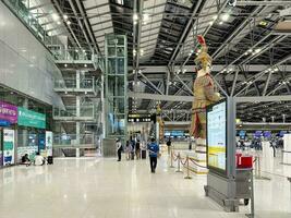 Terminal interior of Suvarnabhumi Airport, Samut Prakan, Thailand, showcasing its departure floor corridor on the evening of July 7, 2023. photo