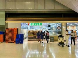 On July 7, 2023, nighttime snapshot of a busy 7-11 store situated in the departure area of Suvarnabhumi Airport, Bangkok, Thailand. photo