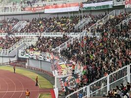 Surabaya, indonesia - 22 june 2023 - A view and atmosphere with many indonesia supporter at gelora bung tomo. Indonesia vs palestina friendly match. photo