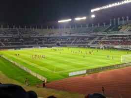 Surabaya, indonesia - 22 june 2023 - A view and atmosphere with many indonesia supporter at gelora bung tomo. Indonesia vs palestina friendly match. photo