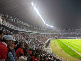 Surabaya, indonesia - 22 june 2023 - A view and atmosphere with many indonesia supporter at gelora bung tomo. Indonesia vs palestina friendly match. photo