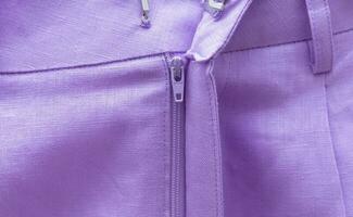 Street style fashion linen shorts close-up, classic summer style outfit, bright purple colors. photo