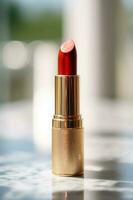 Luxurious red lipstick in golden tube on marble, beauty cosmetic and luxury make-up product, generative ai photo