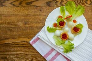 background of red caviar on dsrk wooden surface. tartlets with red caviar photo