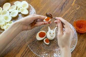 Step by step. egg rabbit figurine for decoration for making stuffed eggs photo
