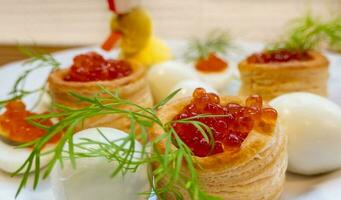 Closeup of caviar and cream cheese appetizer on crackers photo