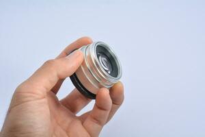 camera lens on hand on a white background photo