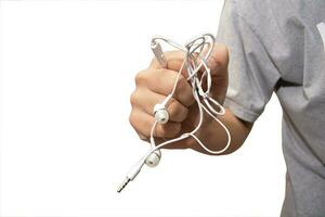 a man with tangled headphones in a twisted mess isolate white background photo